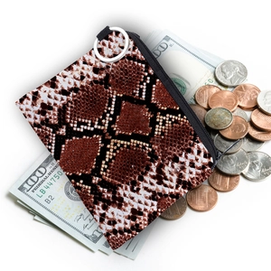 Portable snakeskin pattern small coin purse with silver zipper and cash props on white