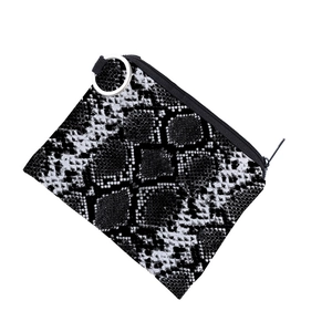 Detail of snake print coin purse with a black zipper closure and silver metal ring