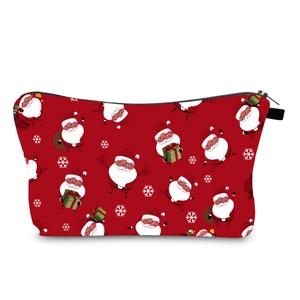 Detailed view of red Christmas makeup bag with Santa Claus and snowflake prints