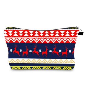 Detail of Christmas reindeer print and snowflake pattern on festive travel makeup bag