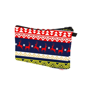 Detail of Christmas reindeer pattern on canvas travel makeup bag with black zipper