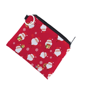 Detailed view of red Christmas coin purse with Santa Claus pattern and metal ring hook