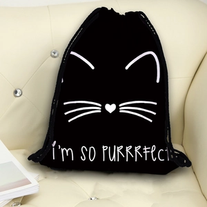 Black drawstring travel bag with minimalist white cat print and SO PURRRFECT text on a sofa