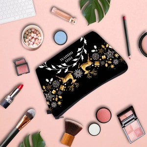 Flat lay of Christmas reindeer makeup bag with Merry Christmas print and beauty tools