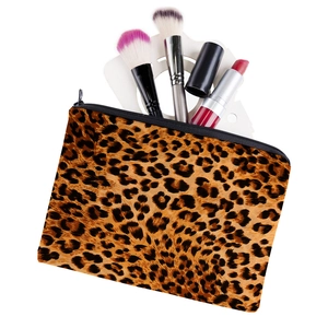 Square leopard print oxford makeup bag with brushes and lipstick on white background