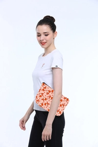 Detail of waterproof Corgi print toiletry bag held by a model with a zipper closure