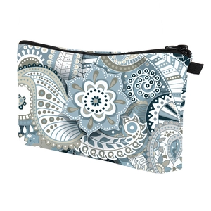 Detail of blue paisley floral patterns on waterproof fabric with black zipper closure