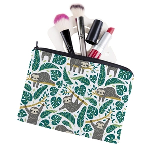 Square makeup bag with sloth and tropical leaf print, including zipper closure and brushes