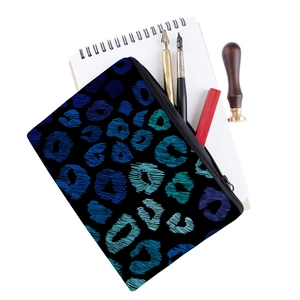 Detailed close-up of a blue leopard print zipper pouch with office stationery accessories