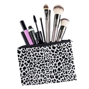 Detail shot of leopard print cosmetic bag with brushes showing storage capacity