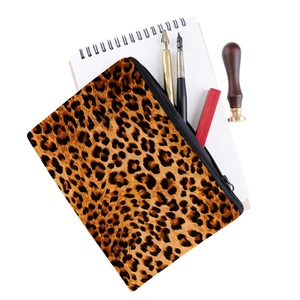 Close-up of leopard print oxford makeup bag with stationery items and zipper detail