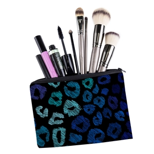 Close-up of leopard print makeup bag with makeup brushes, mascara and eye liner inside