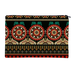 Detail view of ethnic mandala print storage bag with red floral patterns and metal zipper