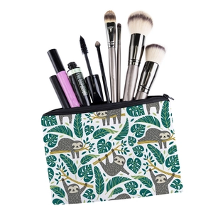 Square makeup bag with cute sloth print and various cosmetic brushes inside the zipper pouch