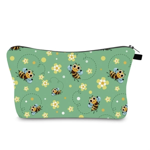 Detailed view of water-resistant green makeup bag with cartoon bee and floral print