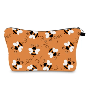 Close-up of waterproof travel makeup bag with cute bee prints and smooth black zipper
