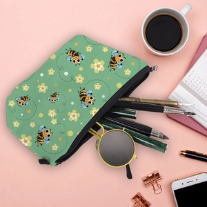 Flat lay of a mint green bee print pouch storage for pens and sunglasses