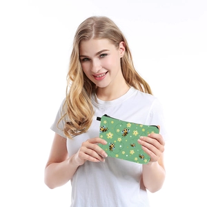 Detail of water-resistant cosmetic bag featuring bee and flower prints with a smooth zipper