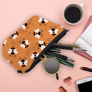 Waterproof orange cosmetic bag with bee prints holding sunglasses and pens