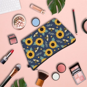 Water-resistant travel makeup bag featuring sunflower and bee patterns with zipper closure