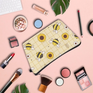 Travel makeup bag with bee and sunflower print featuring top zipper closure