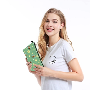 Waterproof toiletry bag with green bee pattern and floral prints for travel storage