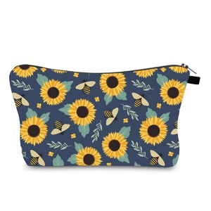 Macro detail of waterproof sunflower and bee print fabric with black zipper closure