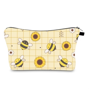 Close-up of cute bee and sunflower print on yellow gingham travel toiletry bag