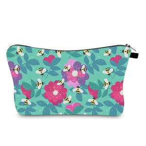 Detail view of water-resistant mint green makeup bag with floral and bee pattern prints