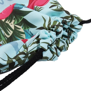 Light blue drawstring backpack with vibrant flamingo and palm leaf tropical print