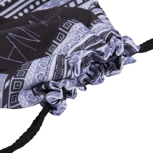 Detailed macro view of the drawstring closure and geometric tribal pattern on the backpack