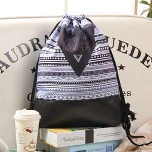 Ethnic geometric pattern drawstring backpack with leather base and Hakuna Matata print