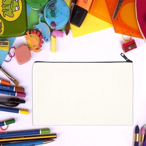 DIY sublimation blank canvas makeup bag with black zipper and surrounding stationery tools