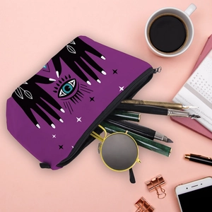 Detailed top view of waterproof cosmetic bag with Evil Eye prints on a pink desk