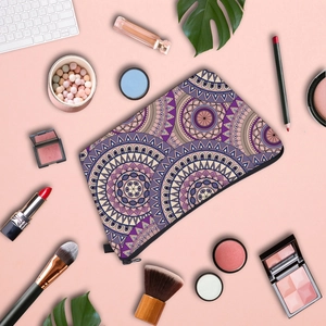 Mandala print waterproof makeup bag with purple bohemian pattern on a desk setting