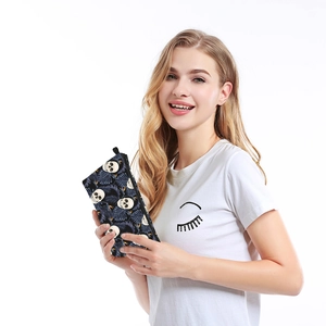 Detailed view of the dark tropical skull print and waterproof zipper of the cosmetic bag