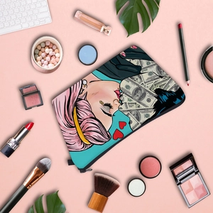 Flat lay of water-resistant pop art cosmetic bag with stylish illustration and makeup tools