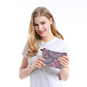 Woman holding a waterproof mandala print makeup bag with a vintage purple pattern