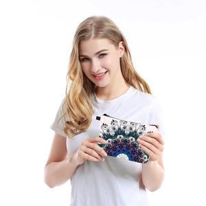 Close-up of waterproof mandala print makeup bag held by model for travel storage