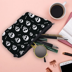 Waterproof skull makeup bag with heart eyes and zipper, styled on pink desk background