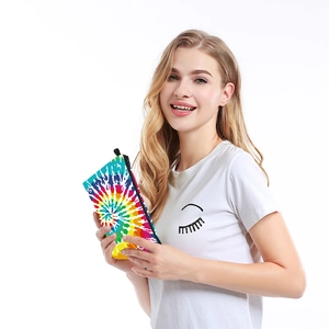 Woman holding water-resistant colorful tie-dye travel makeup pouch with black zipper