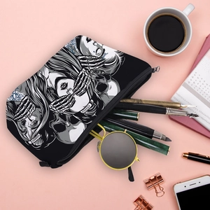 Flat lay of a waterproof makeup bag with skull print on a pink desk background