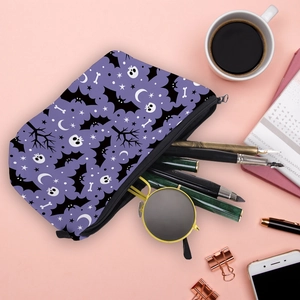 Halloween purple makeup bag with bat and skull patterns on pink aesthetic background