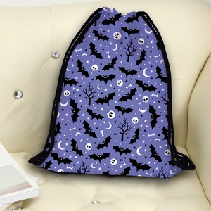 Halloween purple drawstring backpack with bat and skull prints on a leather sofa