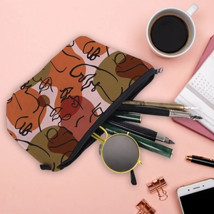 Waterproof toiletry bag with abstract face art print and zipper on pink desk