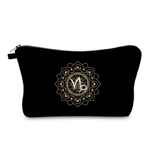 Close-up of waterproof black toiletry bag showing golden mandala and Capricorn print