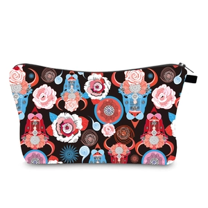 Macro detail of waterproof vanity bag showing digital floral print and metal zipper closure