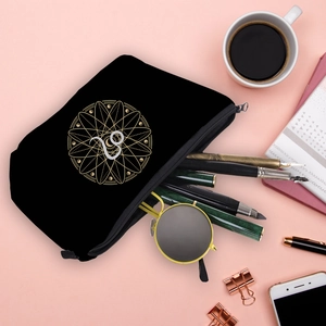 Detailed flatlay of waterproof black Capricorn zodiac cosmetic bag with stationery