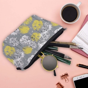 Water-resistant dandelion print travel makeup bag with sleek zipper on pink background