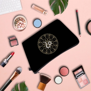 Waterproof black zodiac cosmetic bag with gold Capricorn print and makeup accessories